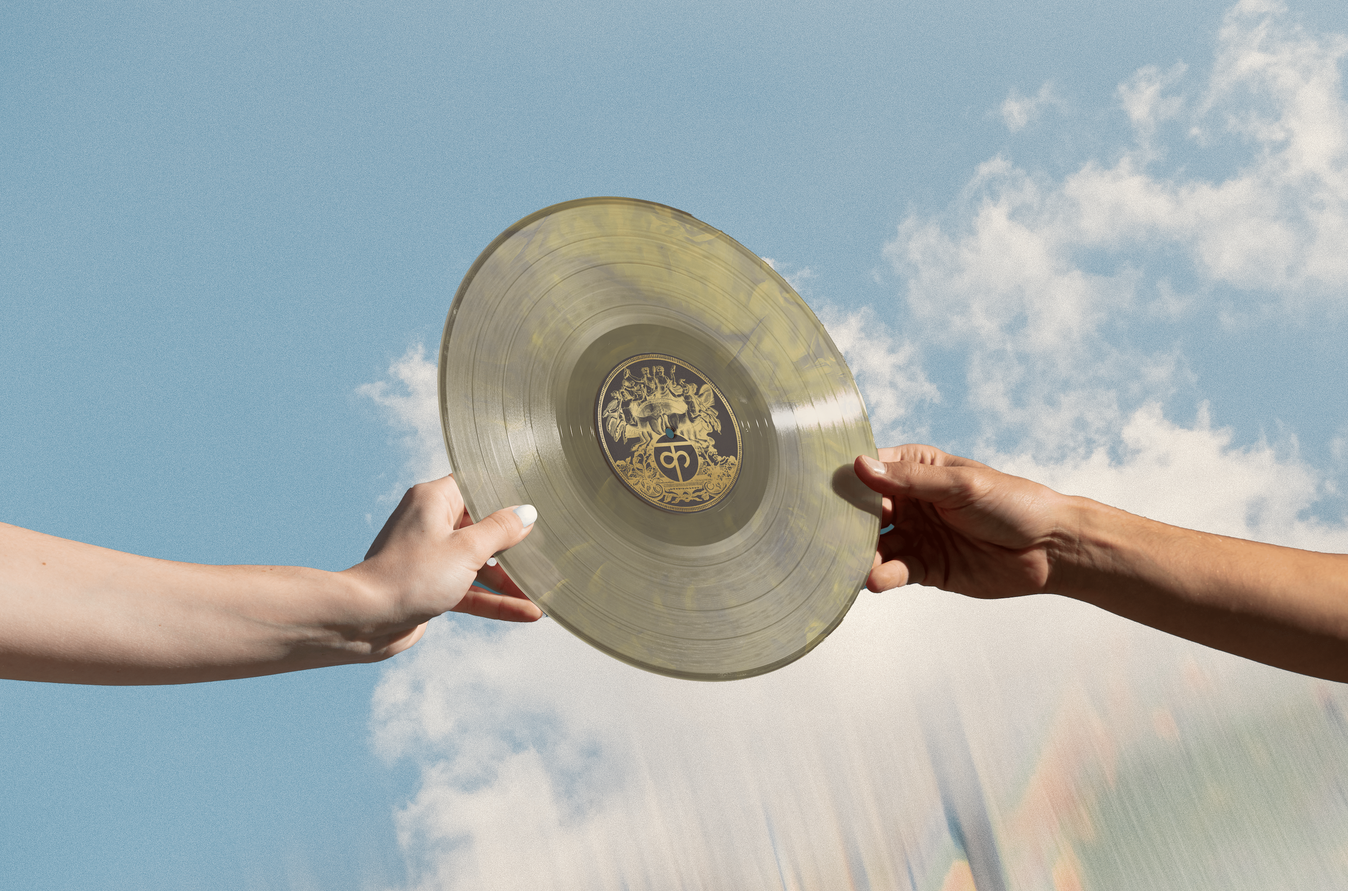 "The Sound"; Two hands holding up a vinyl record with the brand logo with a refractive sky background